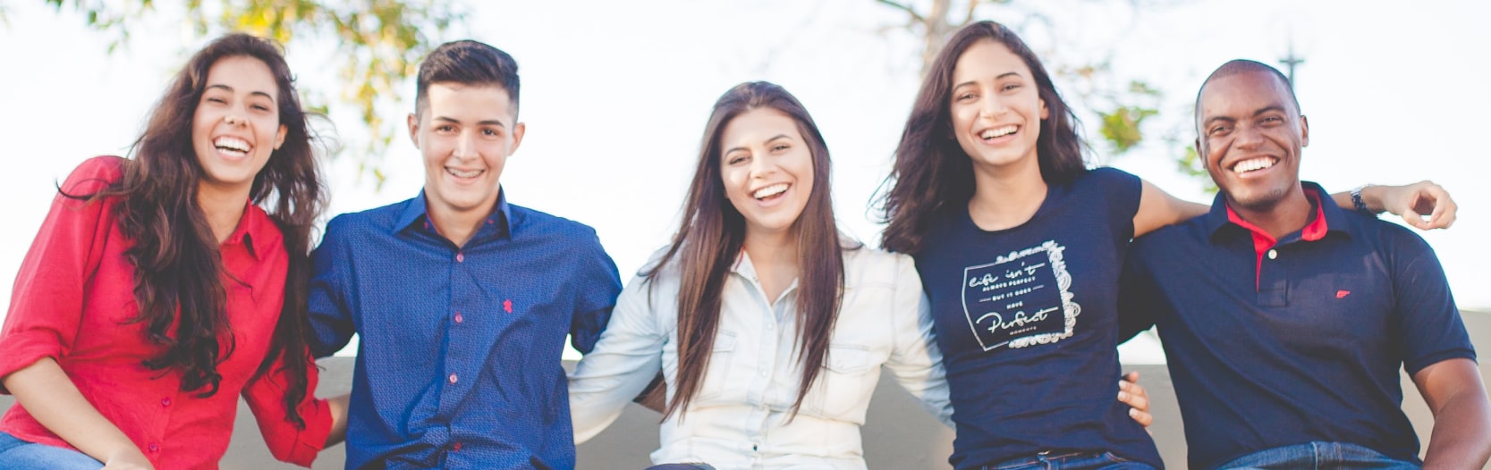 five people hugging and smiling