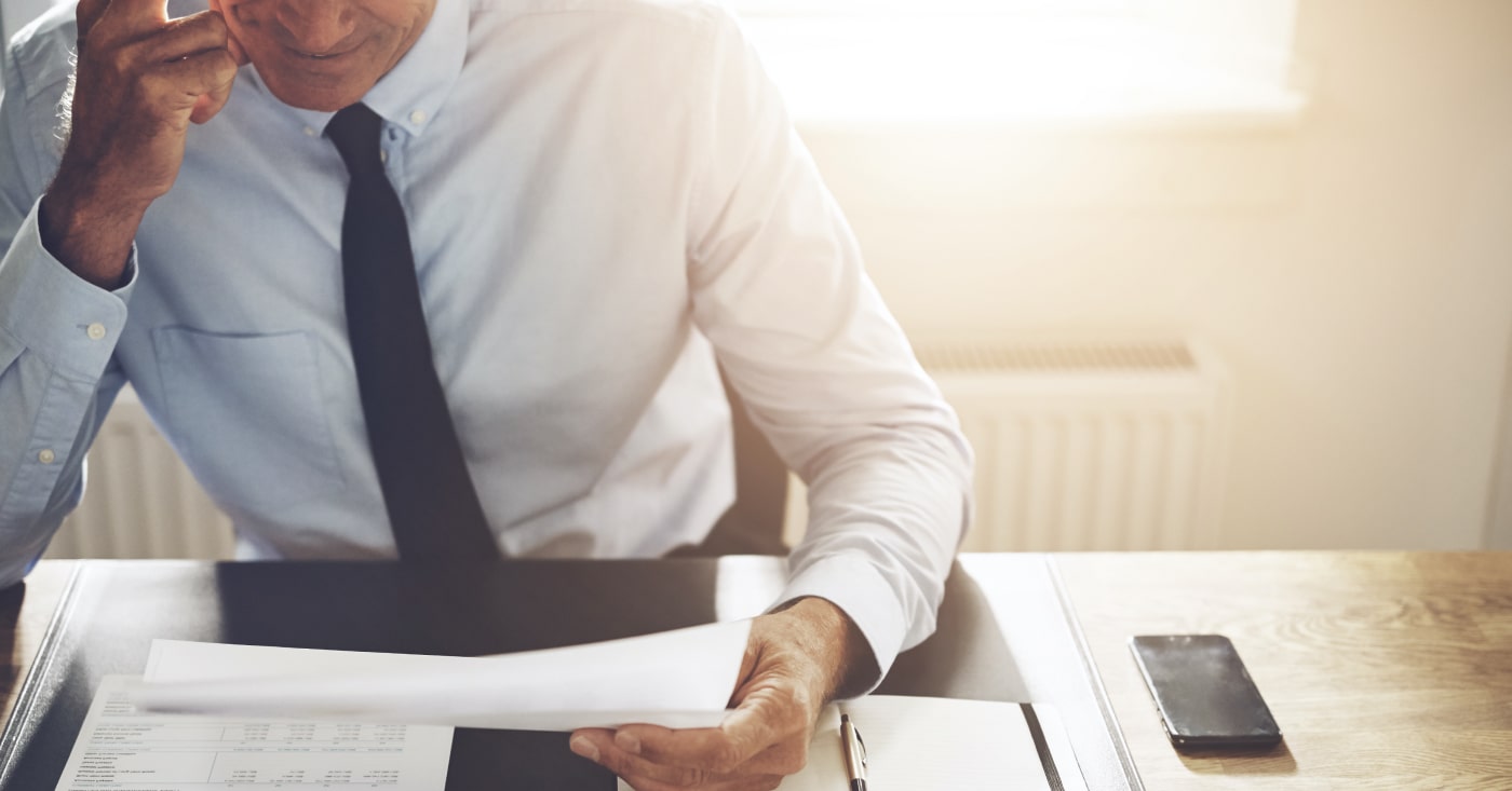 man in tie sitting at a desk